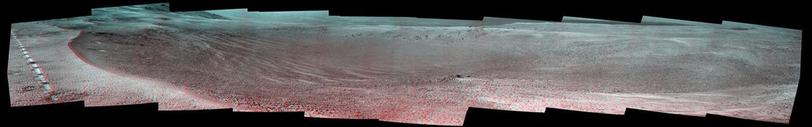 This view of a 90-foot-wide, relatively fresh crater on Mars, "Orion Crater," combines images from the left eye and right eye of the Panoramic Camera (Pancam) on NASA's Mars Exploration Rover Opportunity. It appears three-dimensional when seen through blue-red glasses with the red lens on the left.