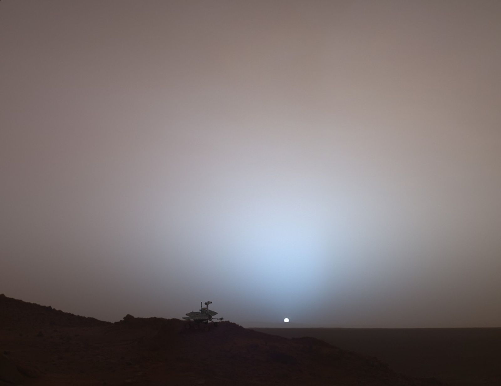 This synthetic image of the Spirit Mars Exploration Rover on top of a rock called "Jibsheet" was produced using "Virtual Presence in Space" technology.