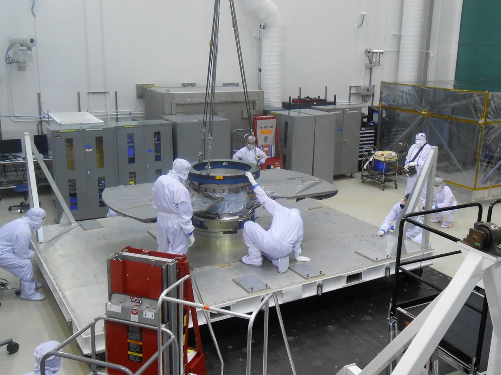 Lockheed Martin spacecraft specialists check the cruise stage of NASA's InSight spacecraft in this June 22, 2017, photo. The cruise stage will provide vital functions during the flight from Earth to Mars, and then will be jettisoned before the rest of the spacecraft enters Mars' atmosphere.