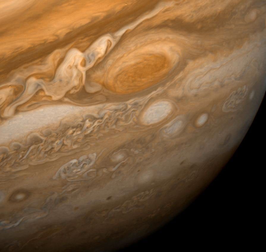 This dramatic view of Jupiter's Great Red Spot and its surroundings was obtained by NASA's Voyager 1 on Feb. 25, 1979. The colorful, wavy cloud pattern to the left of the Red Spot is a region of extraordinarily complex end variable wave motion.