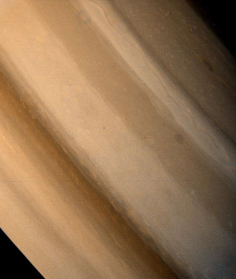 Two brown ovals, at right, some 10,000 km (6,000 miles) across, were found at approximately 40` and 60` latitude in Saturn's northern hemisphere by NASA's Voyager 1. The photo was taken on November 7, 1980.