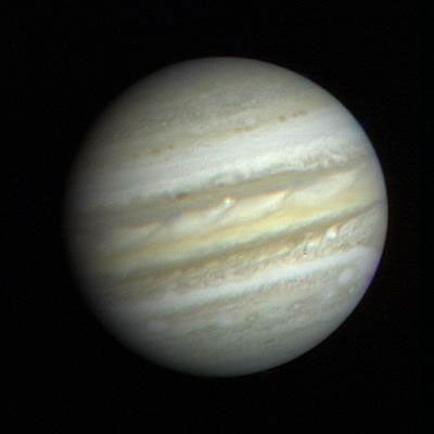 A global view of Jupiter with the planet appearing to be covered in bands of yellow, tan, and beige.