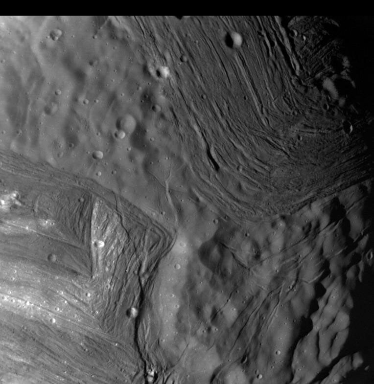This image of Miranda, obtained by NASA's Voyager 2 on approach in 1986, shows an unusual 'chevron' figure and regions of distinctly differing terrain on the Uranian moon.