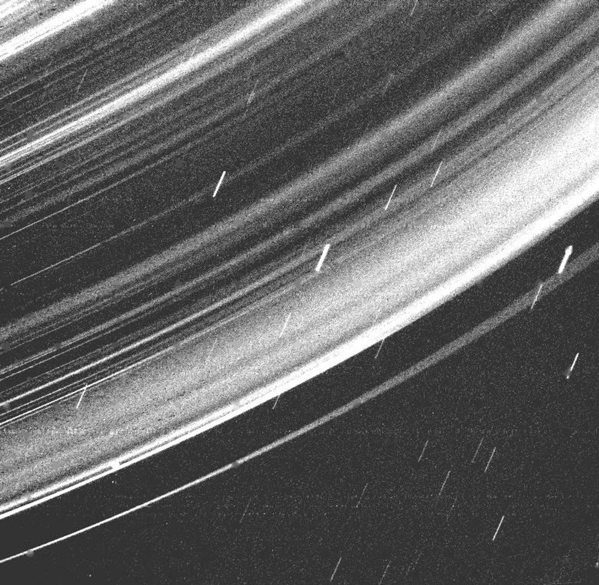 Backlit Voyager 2 view revealing fine dust throughout the Uranus ring system