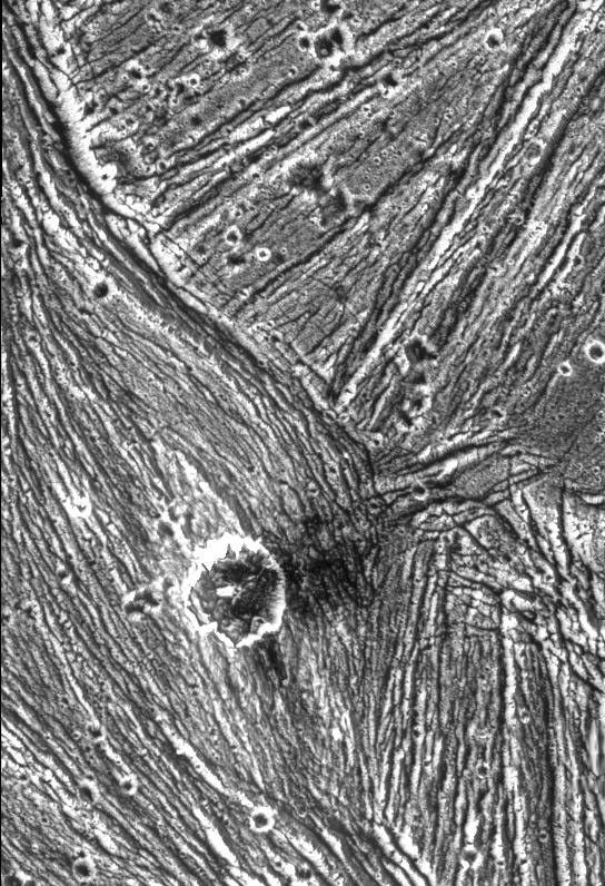A mixture of terrains studded with a large impact crater is shown in this view of the Uruk Sulcus region of Jupiter's moon Ganymede taken by NASA's Galileo spacecraft during its first flyby of the planet-sized moon on June 27, 1996.