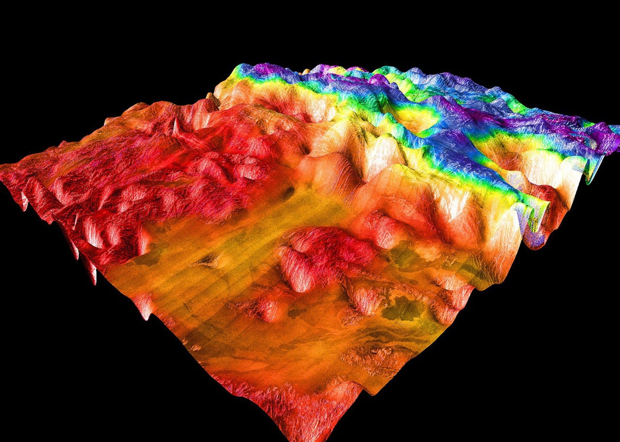 This perspective view of Venus, generated by computer from NASA's Magellan data and color-coded with emissivity, shows the boundary between the lowland plains and characteristic Venusian highland terrain in Ovda Regio.