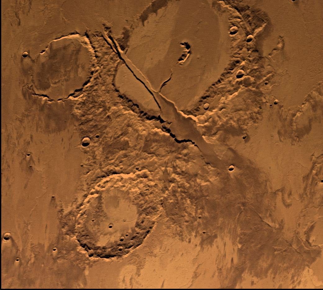 NASA's Viking Orbiter 2 shows Tharsis-centered volcanic and tectonic activity resulted in the formation of radial grabens of Memnonia Fossae, which cut materials of the ancient cratered highlands and the relatively young, highland-embaying lava flows.