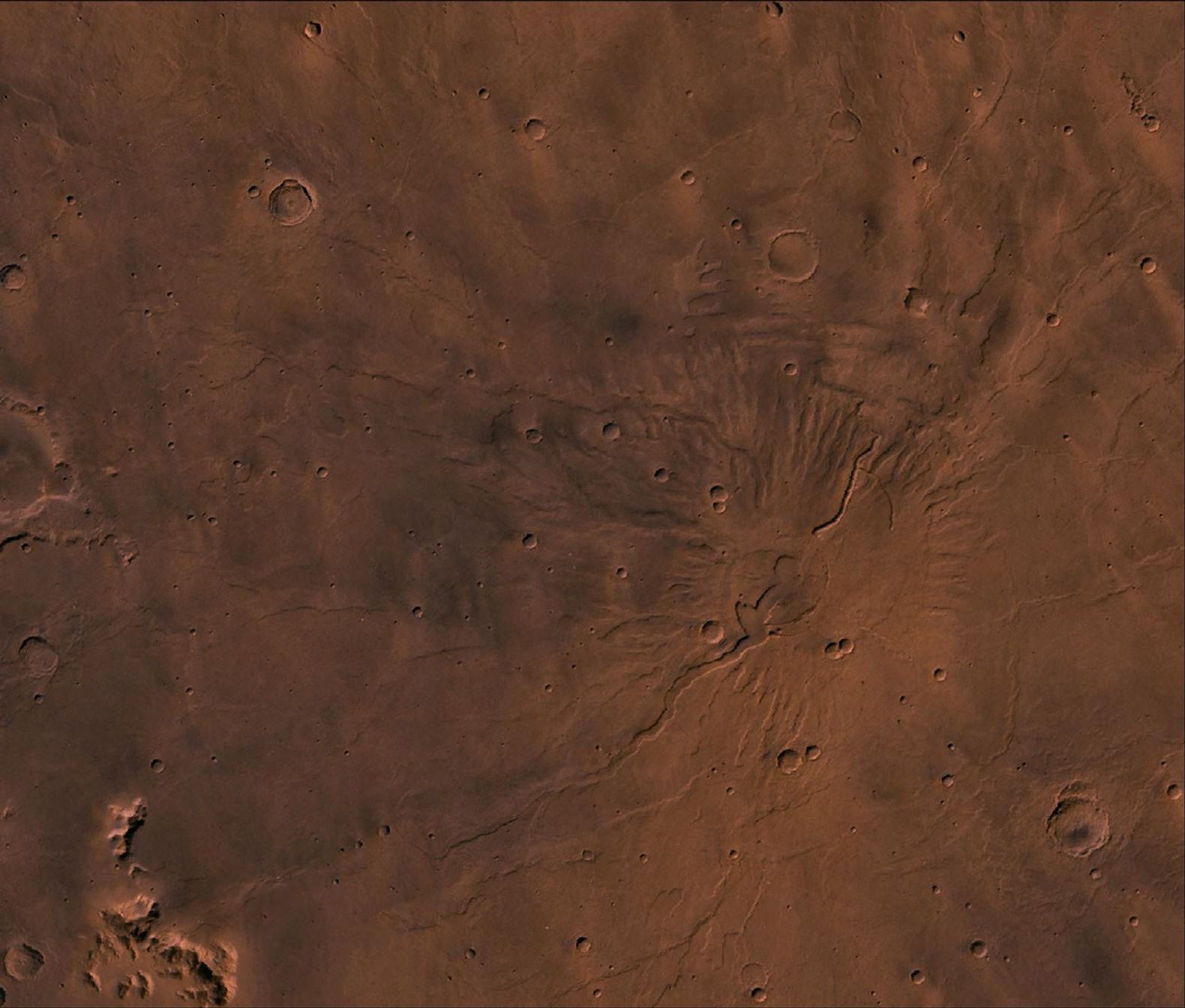 Tyrrhena Patera Region of Mars. Theis scene shows a central circular depression surrounded by circular fractures and highly dissected horizontal sheets, as seen by NASA's Viking spacecraft.
