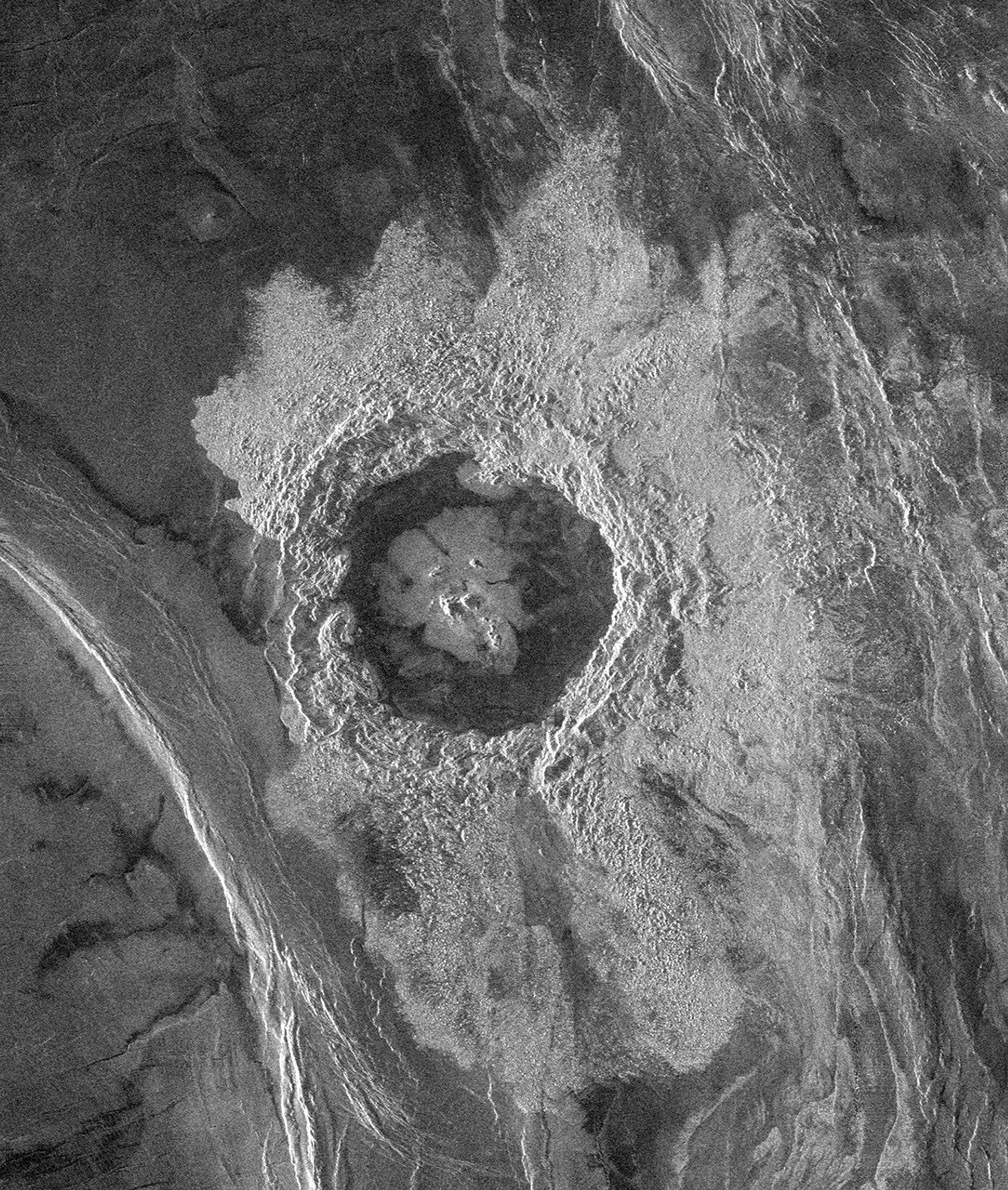 This image from NASA's Magellan spacecraft is from the northeastern Atalanta Region of Venus. The image shows the complex impact crater, Dickinson, characterized by a partial central ring and a floor flooded by radar-dark and radar-bright materials.