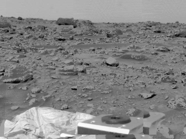 An area of very rocky terrain at the Ares Vallis landing site, along with the lander's deflated airbags, were imaged by NASA's Imager for Mars Pathfinder (IMP) on July 6, 1997.