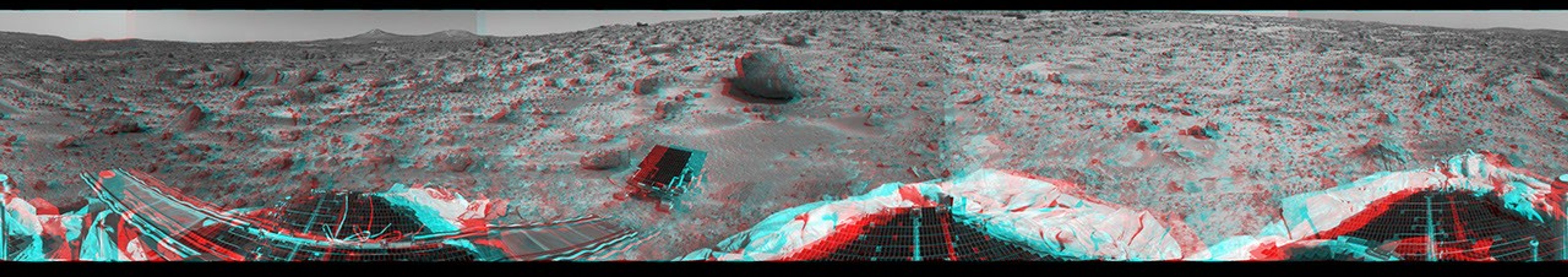 This 360-degree panorama was taken by NASA's Mars Pathfinder. Three petals and the perimeter of the deflated airbags are seen in the foreground. 3D glasses are necessary to identify surface detail.
