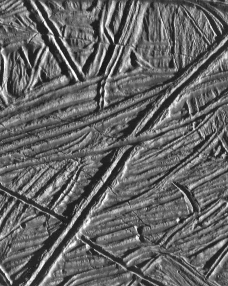 This high resolution image of the icy plains on Europa shows multiple sets of cross-cutting ridges. Many of these ridges are cut by younger fractures. NASA's Galileo spacecraft obtained this image on February 20, 1997.