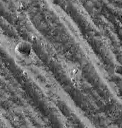 NASA's Galileo spacecraft obtained this image on September 6, 1996 showing ridges on the edge of Ganymede's north polar cap.