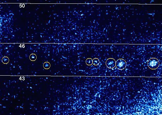 The knots of light which have been circled in yellow in this false color picture probably represent lightning in Jupiter's atmosphere. The picture was taken through the clear filter of the solid state imaging (CCD) system aboard NASA's Galileo spacecraft.