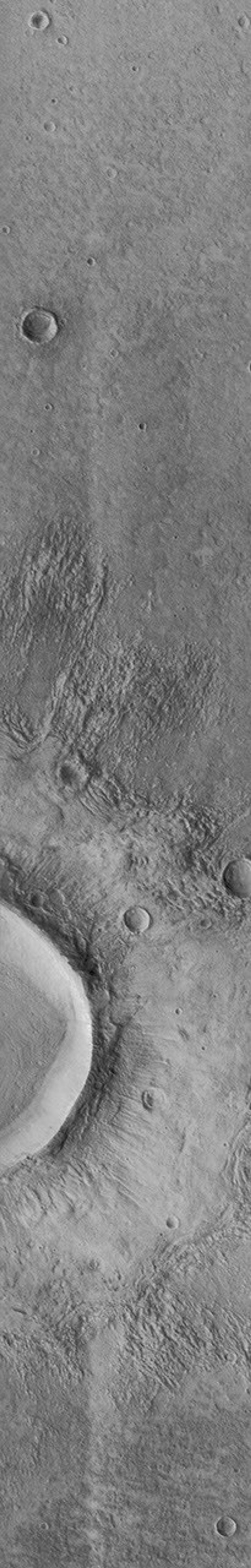 NASA's Mars Global Surveyor acquired this image of a flow ejecta crater on November 19, 1997. Flow ejecta craters are so named because the material blasted out of the crater during the impact process appears to have flowed across the surface of Mars.