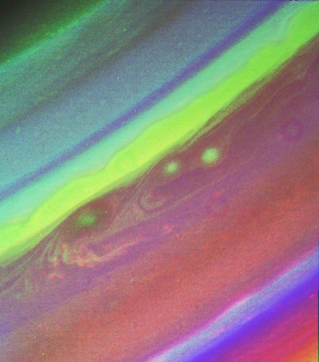 This false color picture of Saturn's northern hemisphere was assembled from ultraviolet, violet and green images obtained Aug. 19, 1998 by NASA's Voyager 2. The several weather patterns evident include three spots flowing westward.