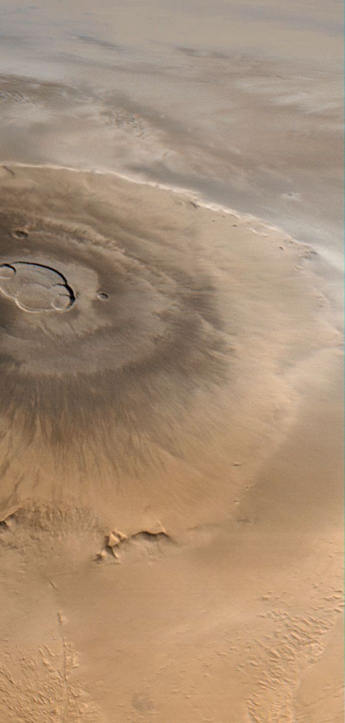 This image taken on April 25, 1998 by NASA's Mars Global Surveyor shows Olympus Mons, a mountain on Mars. About as wide as the entire Hawaiian Island chain, this giant volcano is nearly as flat as a pancake.