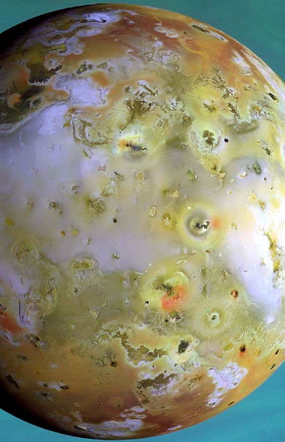 This is the highest resolution color picture taken so far of Jupiter's volcanic moon Io by NASA's Galileo spacecraft. The fiery satellite is seen against a backdrop of Jupiter's cloud tops, which appear blue in this false-color composite.
