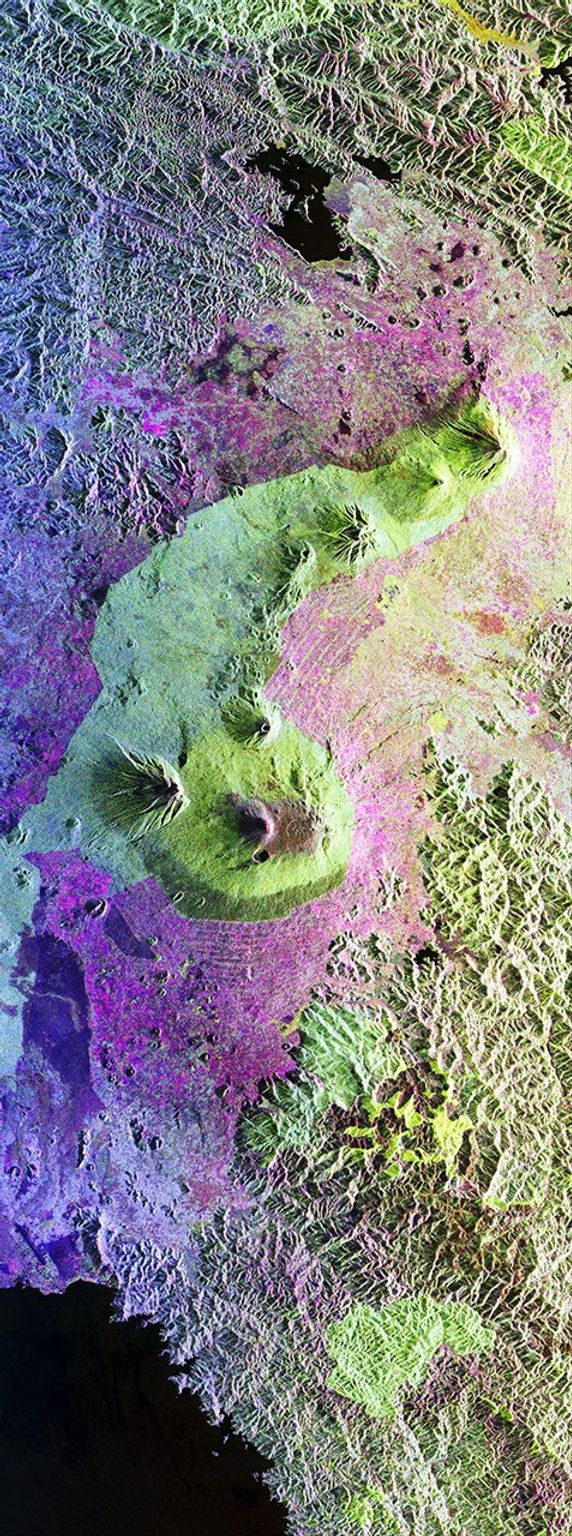 This is a false-color radar image from NASA's Spaceborne Imaging Radar C/X-Band Synthetic Aperture Radar of Central Africa, showing the Virunga Volcano chain along the borders of Rwanda, Zaire and Uganda, home to the endangered mountain gorillas.