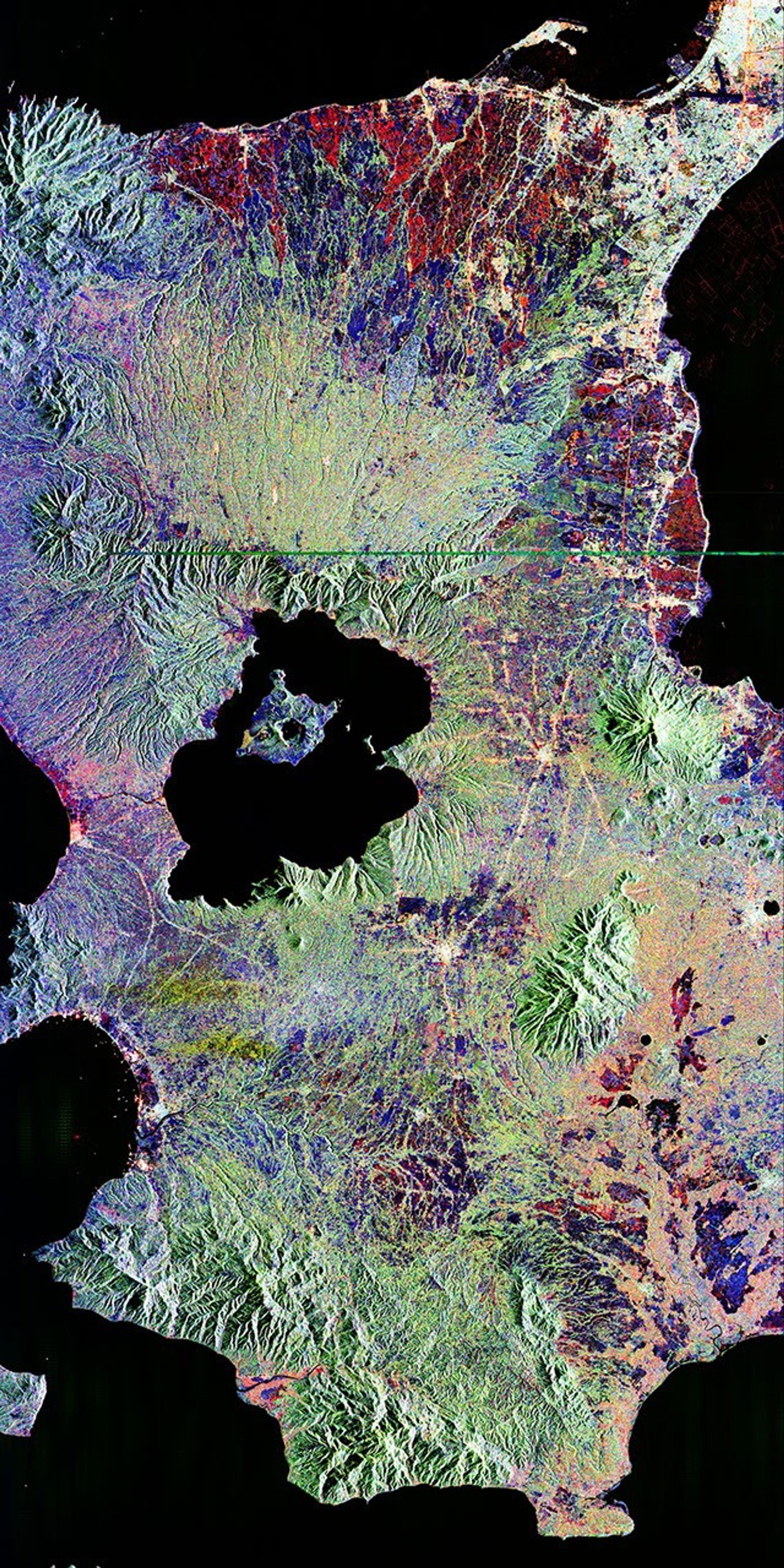 This is an image NASA's Spaceborne Imaging Radar-C/X-band Synthetic Aperture of Taal volcano, near Manila on the island of Luzon in the Philippines. The black area in the center is Taal Lake, which nearly fills the 30-kilometer-diameter (18-mile) caldera.