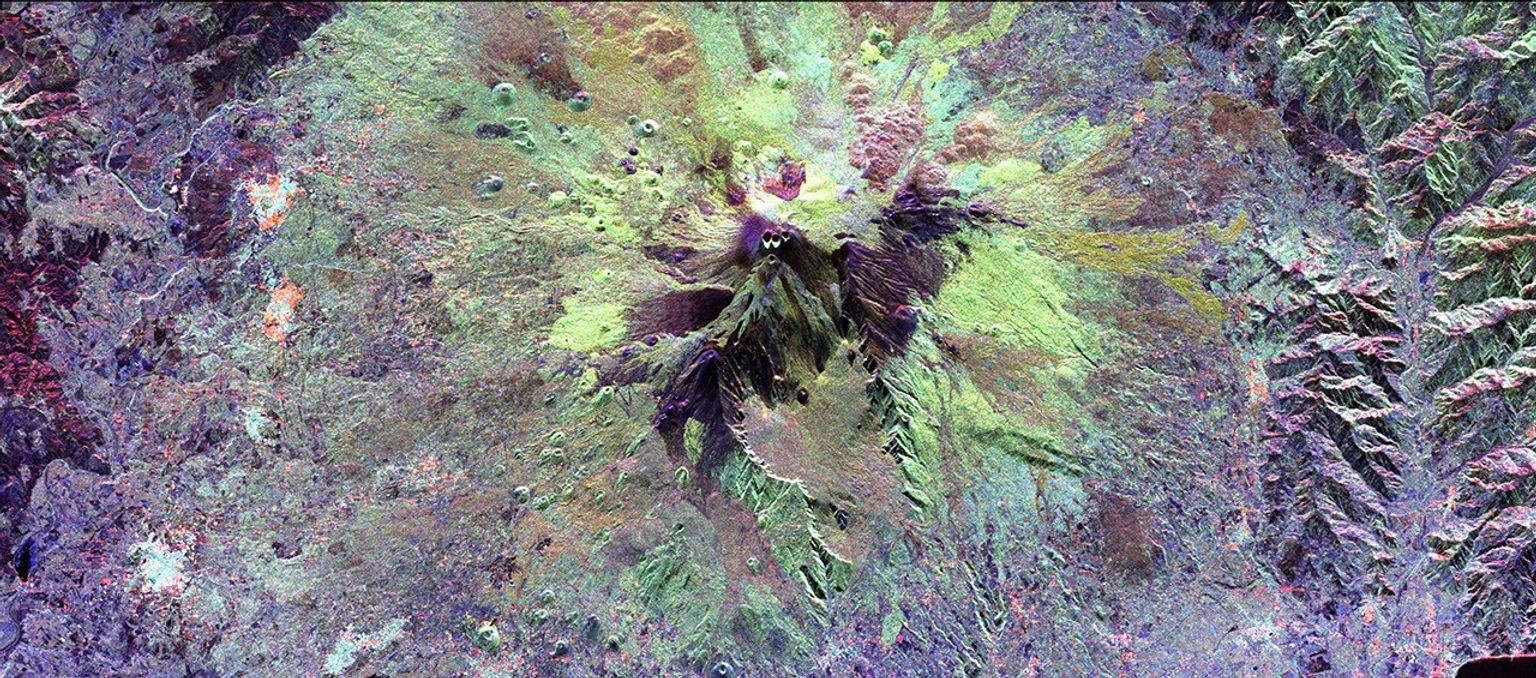 The summit of the Mount Etna volcano on the island of Sicily, Italy, one of the most active volcanoes in the world, is shown near the center of this radar image from NASA's Spaceborne Imaging Radar-C/X-band Synthetic Aperture Radar.