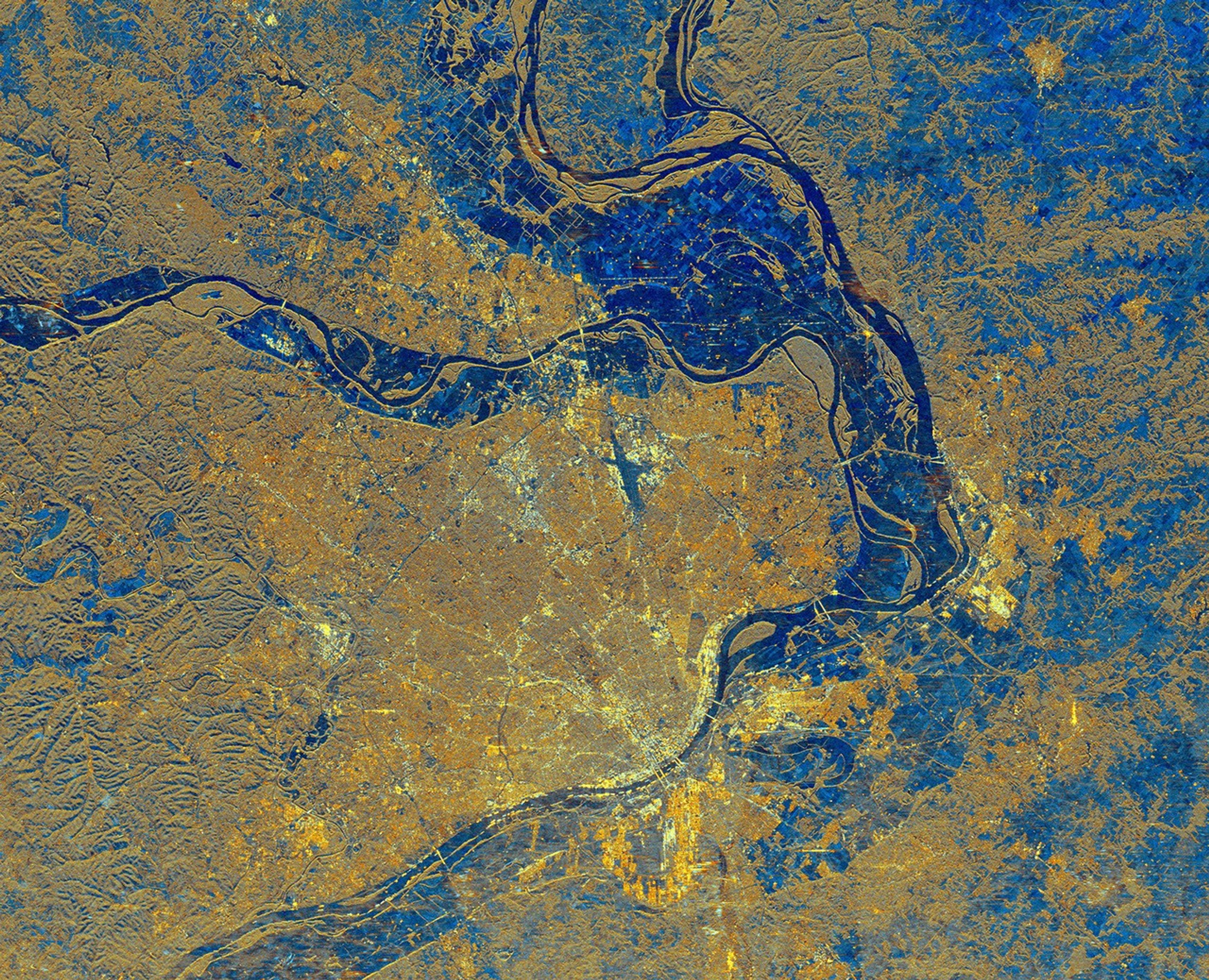 This is an image from NASA's Spaceborne Imaging Radar C/X-Band Synthetic Aperture Radar of St. Louis, Missouri, where the Mississippi and Missouri Rivers come together. St. Louis is the bright gold area within a bend in the Mississippi River.