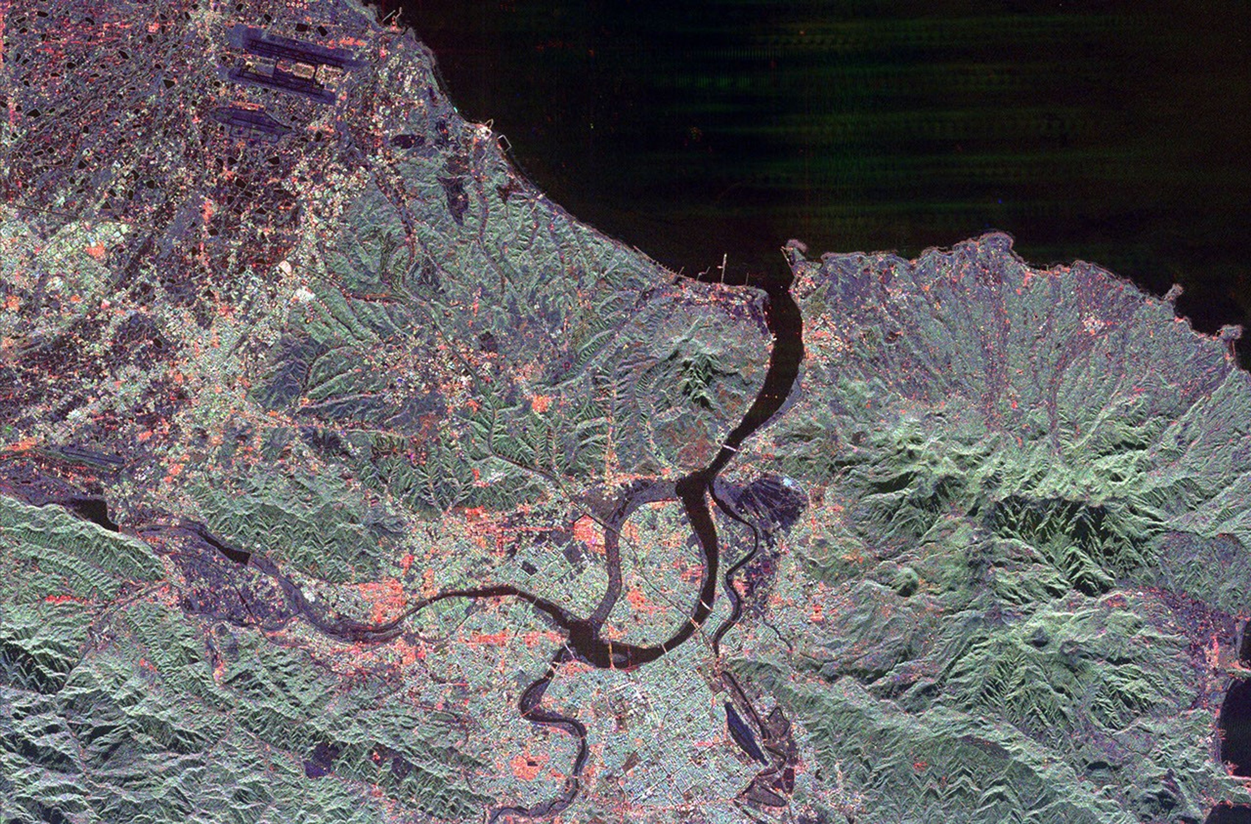The northern end of the island country of Taiwan, including the capital city of Taipei, is shown in this spaceborne radar image from NASA's Spaceborne Imaging Radar C/X-Band Synthetic Aperture Radar. Taipei is the bright blue and red area.