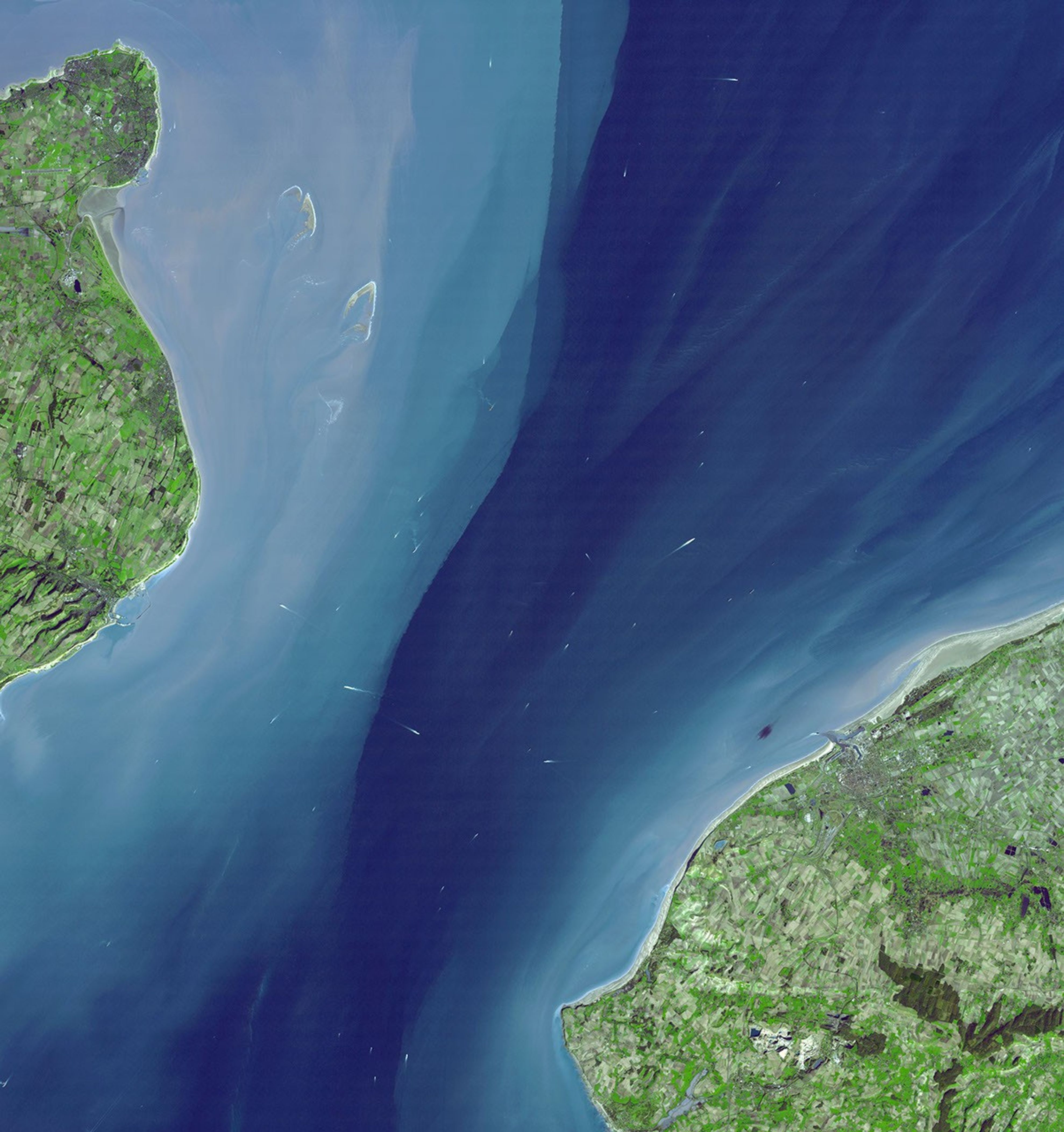 The Channel Tunnel is a 50.5 km-long rail tunnel beneath the English Channel at the Straits of Dover. It connects Dover, Kent in England with Calais, northern France. This image was acquired by NASA's Terra spacecraft.
