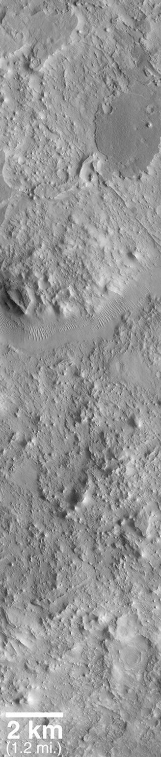 NASA's Mars Global Surveyor shows a portion of the ancient Auqakuh Vallis and many eroded remnants of the ancient cratered terrain.
