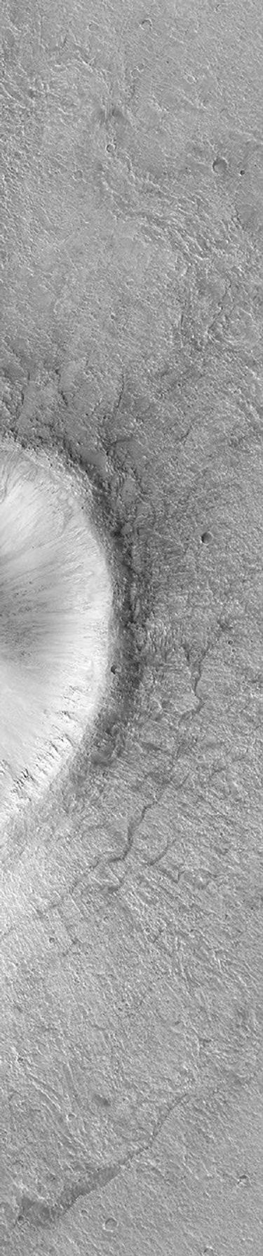 NASA's Mars Global Surveyor shows the eastern third of an impact crater located in Acidalia Planitia on Mars featuring the walls, raised rim, and ejecta material thrown out of the crater during this blast.