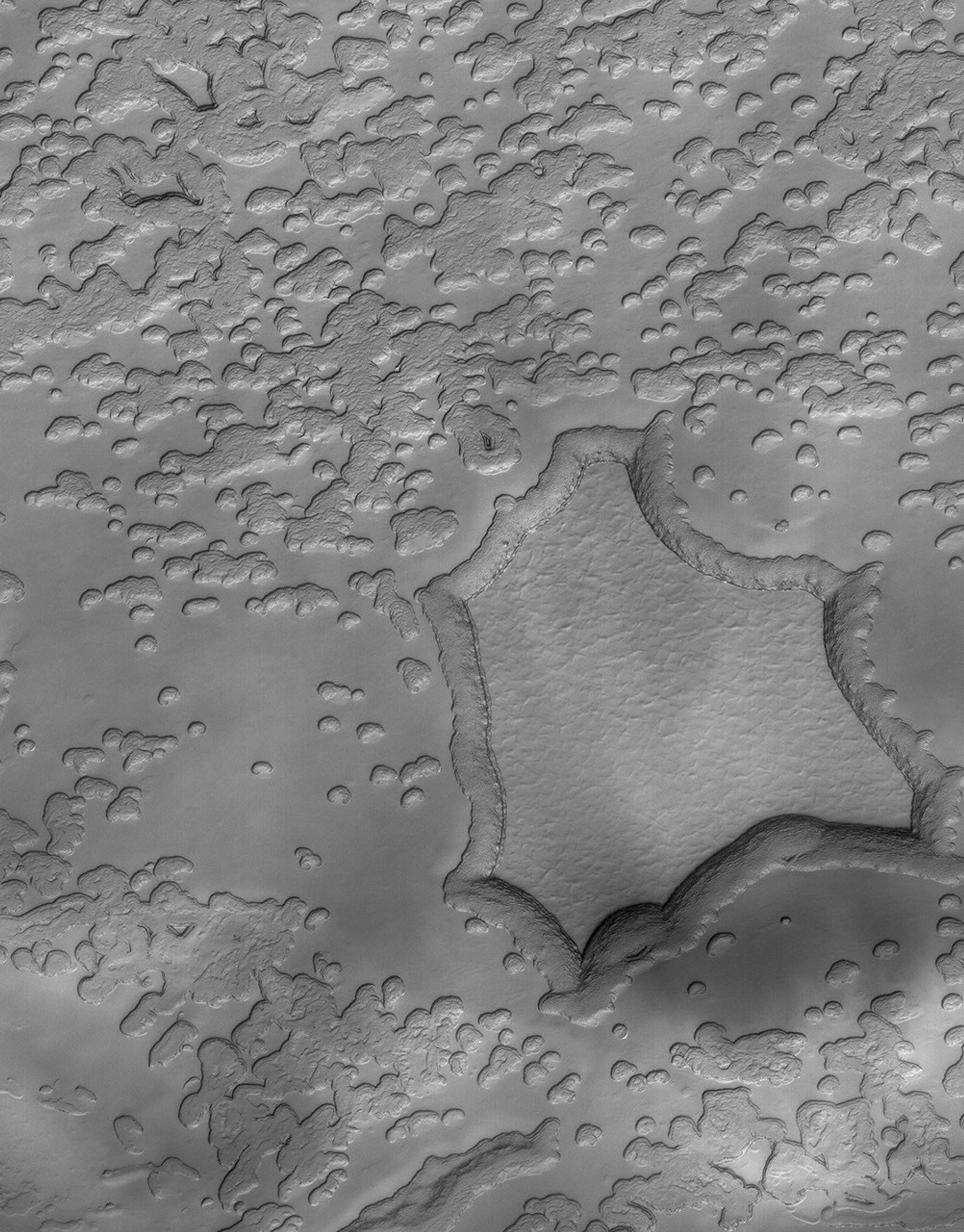 This image from NASA's Mars Global Surveyor shows a portion of the south polar residual cap where the effects of sublimation are apparent. Over extended periods of time, sublimation eats away at the smoother appearing material.