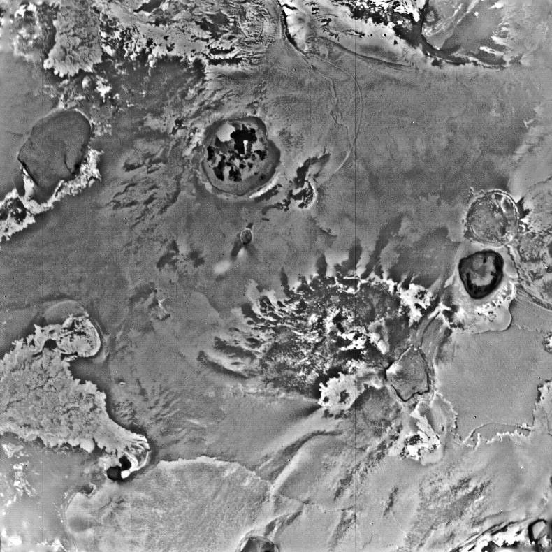 This NASA Voyager 1 view of an equatorial region near longitude 300 degrees shows several large surface flows that originate in volcanic craters or calderas.