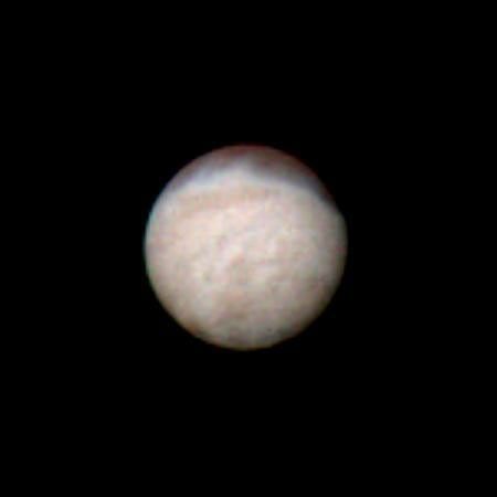 Features as small as 100 km (62 miles) across can be seen in this color image of Neptune's satellite Triton, photographed by NASA's Voyager 2 on Aug. 20, 1989, while it was still 5.4 million km (3.3 million miles) from Neptune.