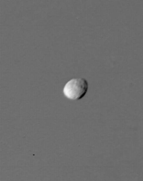 Two satellites of Saturn share an orbit 151,400 kilometers from the center of the planet. The leading co-orbital satellite, designated 1980S1, is seen in transit across Saturn in this image taken by NASA's Voyager 1 on Nov. 12, 1980.