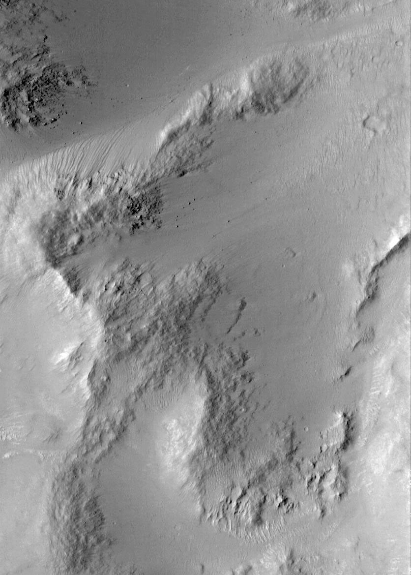NASA's Mars Global Surveyor shows smooth, mantled surfaces, as well as bare, rocky surfaces on Mars.