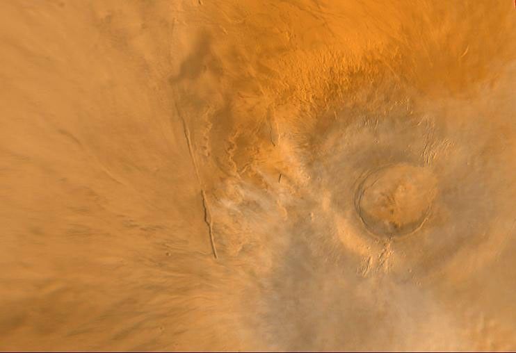 NASA's Mars Global Surveyor shows Arsia Mons, one of the largest volcanoes known on Mars. This shield volcano is part of an aligned trio known as the Tharsis Montes, the others are Pavonis Mons and Ascraeus Mons.