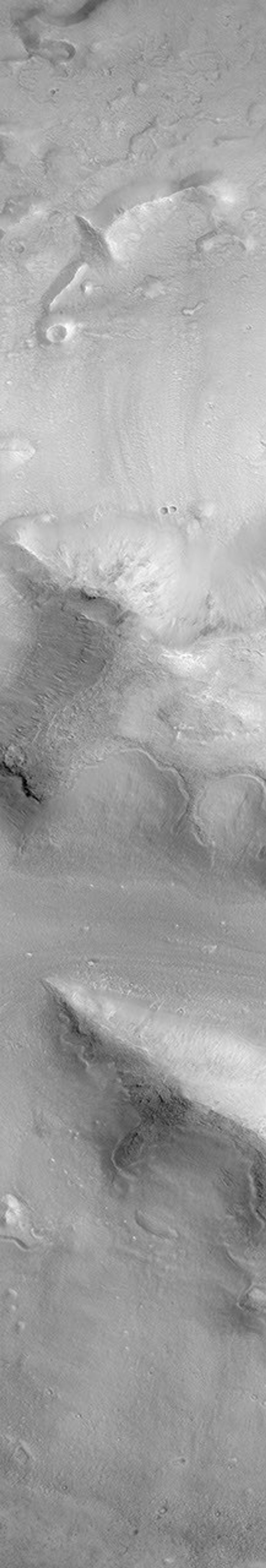 NASA's Mars Global Surveyor shows a group of four small hills surrounded by the larger mountains in the Cydonia region of Mars.