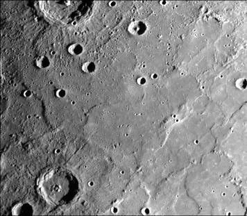 This image, from NASA's Mariner 10 spacecraft which launched in 1974, shows young craters superposed on smooth plains. Larger young craters have central peaks, flat floors, terraced walls, and radial ejecta deposits.