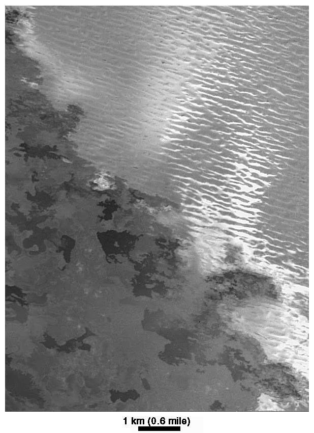 The margin of the lava flow field associated with the Prometheus volcanic plume on Jupiter's moon Io is seen in this image, acquired by NASA's Galileo spacecraft on February 22, 2000. The image has a resolution of 12 meters (39 feet) per picture element.