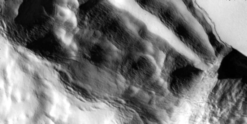 A cliff slumps outward in these high-resolution views that NASA's Galileo spacecraft captured the edge of a mountain named Telegonus Mensa on Jupiter's moon Io.