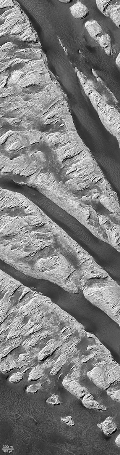 NASA's Mars Global Surveyor shows a ridged mound that was first seen and informally named 'White Rock' located in Pollack Crater on Mars.