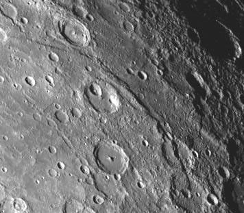 A scarp, or cliff, extends diagonally from upper left to lower right in this picture of Mercury taken by NASA's Mariner 10. The structures are believed to be formed by the compressive forces due to crustal shortening.