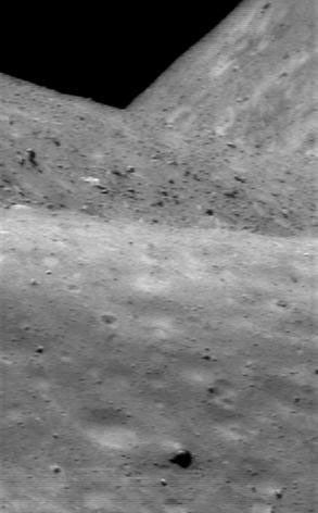 This image of asteroid Eros, taken by NASA's NEAR Shoemaker on July 12, 2000, shows the irregularity of the tiny little world. Looking down the length of the asteroid, one sees near, middle, and far horizons.