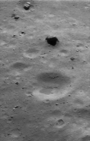This image of asteroid Eros, taken by NASA's NEAR Shoemaker on July 24, 2000, shows large boulders in the scene, such as the broken one at the upper left, showing angular shapes. Many smaller boulders litter the scene; the smallest ones are also visible.