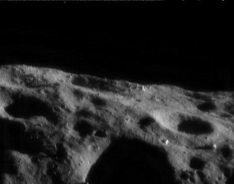 This image of asteroid Eros, taken by NASA's NEAR Shoemaker on Aug. 6, 2000, shows several boulders catching the sunlight and appear like bright sentinels on the landscape.