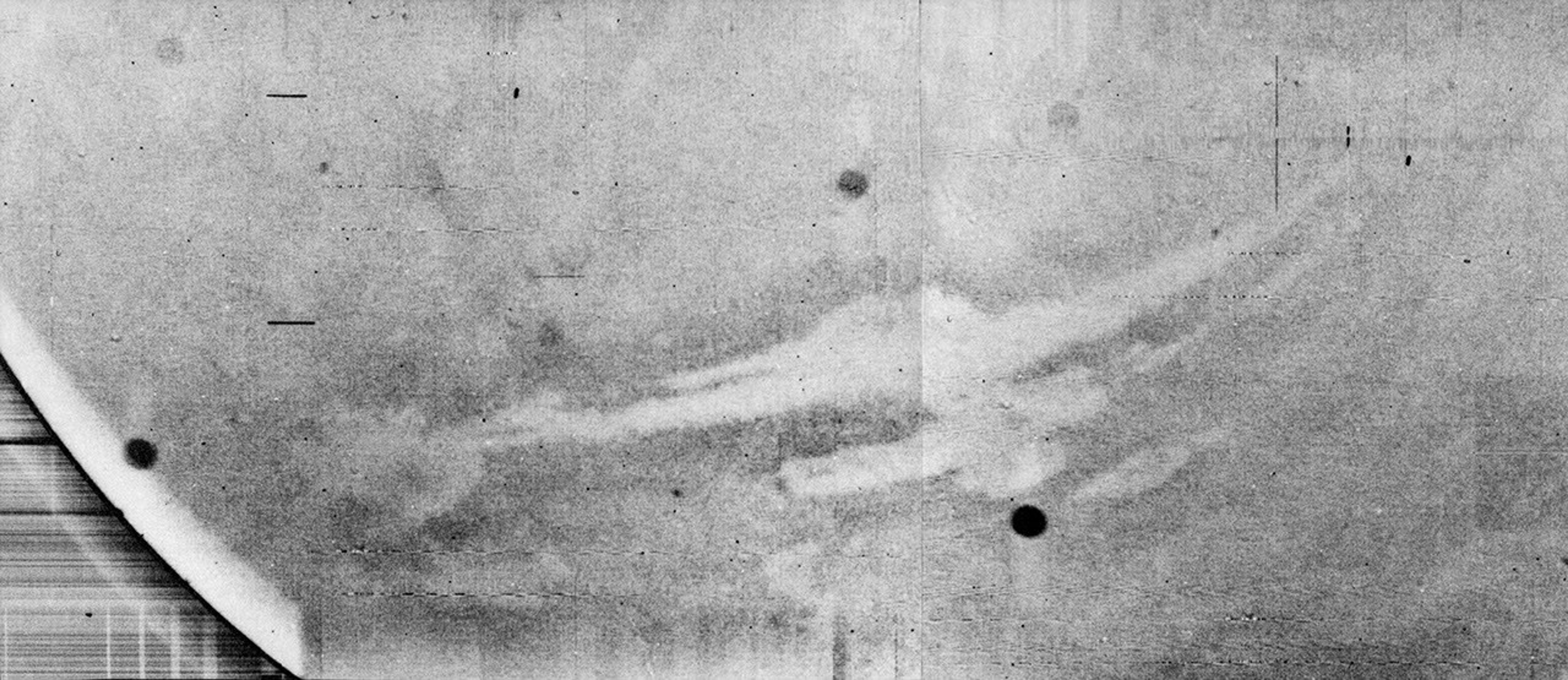 This image from NASA's Mariner 9 taken in 1971 is a view of a canyon system emerging from the Martian dust storm.