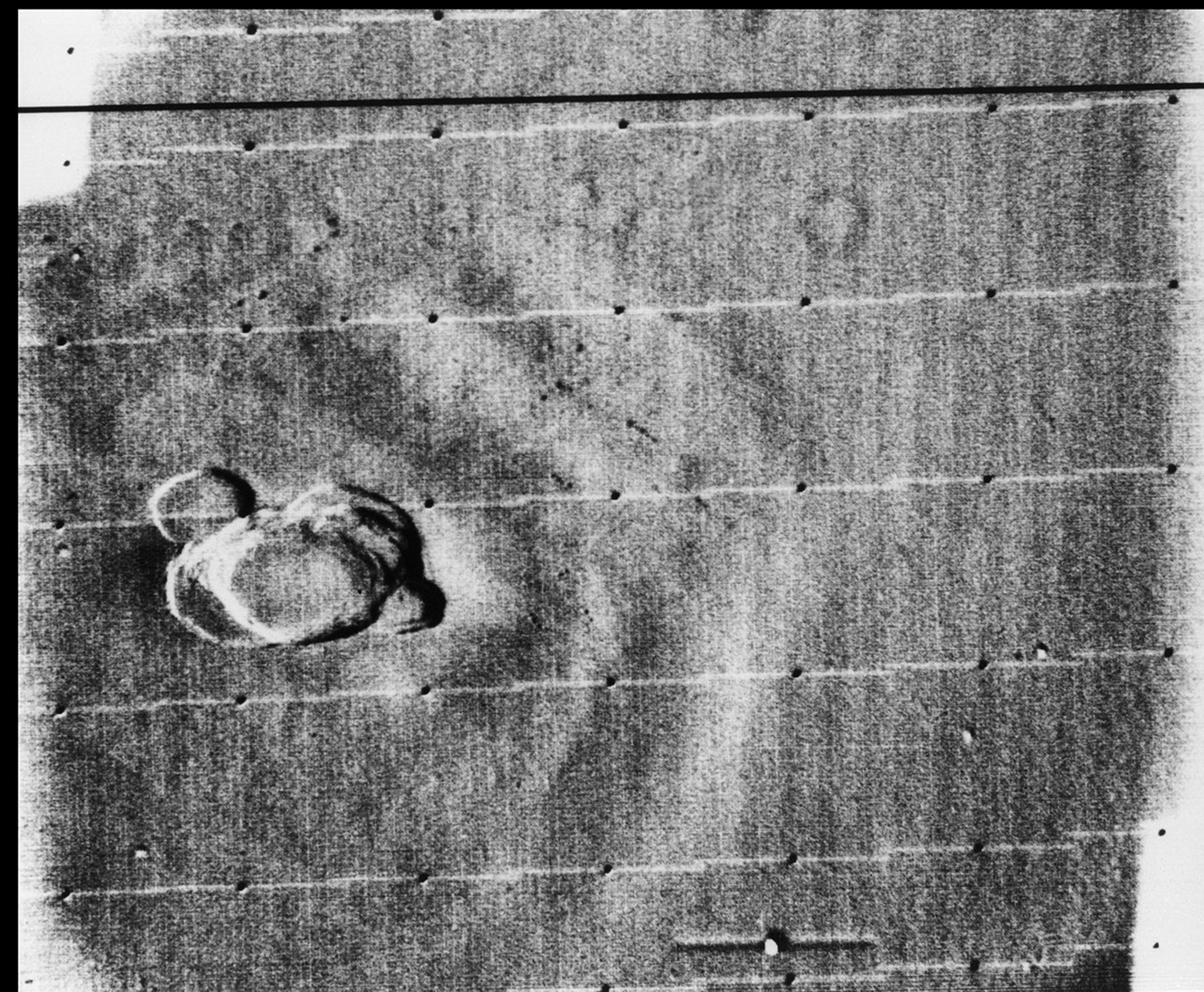 This image from NASA's Mariner 9 taken on Dec. 17, 1971 is a view of a complex crater on the summit of 'north spot' volcano, Ascraeus Mons