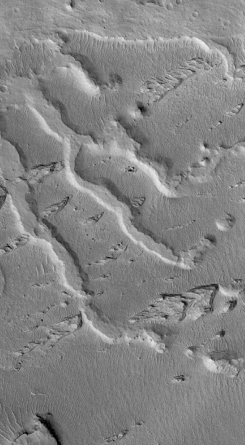 NASA's Mars Global Surveyor shows the inverted remains of several channels in a fan-like complex in the Aeolis region of Mars. The inverted channels are flat-topped ridges that trend from southeast to northwest.