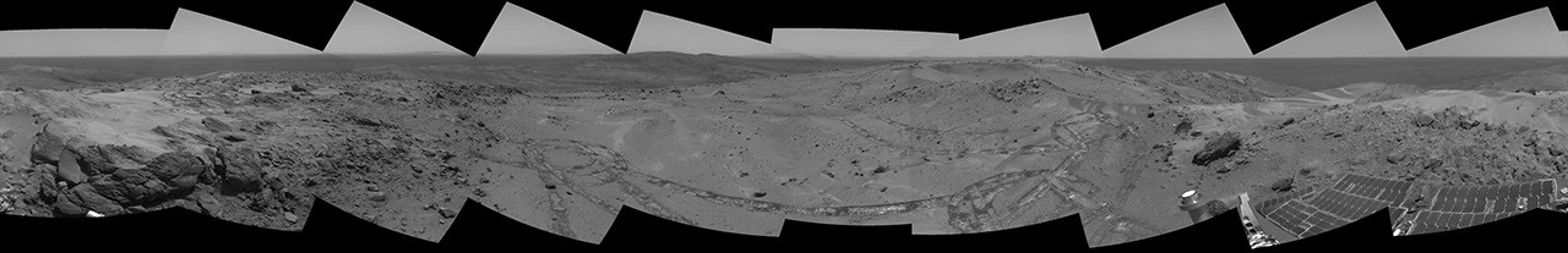 This view from NASA's Mars Exploration Rover Spirit taken on Oct 7, 2005 looked back at the long and winding trail of twin wheel tracks the rover created to get to the top of 'Husband Hill' perched on a lofty, rock-strewn incline.