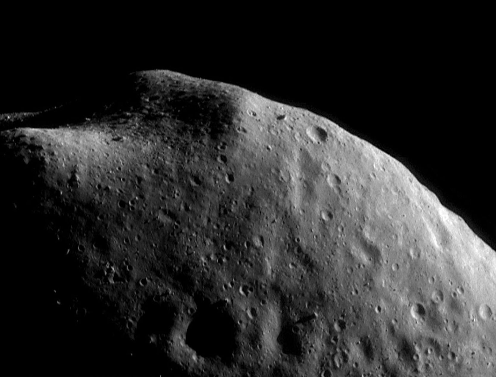 This image of asteroid Eros, taken by NASA's NEAR Shoemaker on Sept. 5, 2000, shows knobs sticking out of the surface near the top of the image surround a boulder-strewn area, robably remnants of ancient impact craters.